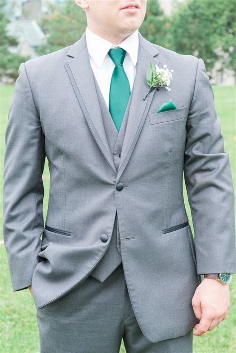 grey suit dark green tie.